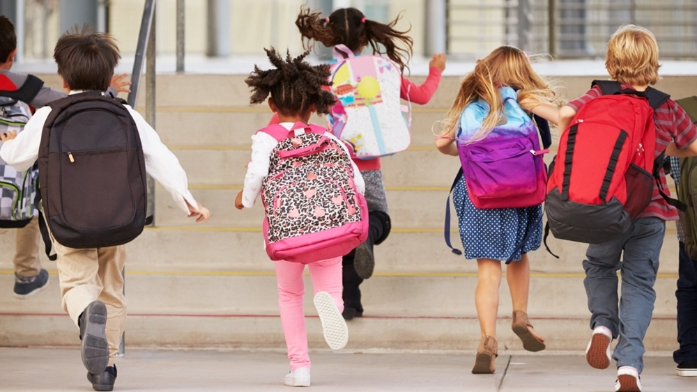 Children running into school